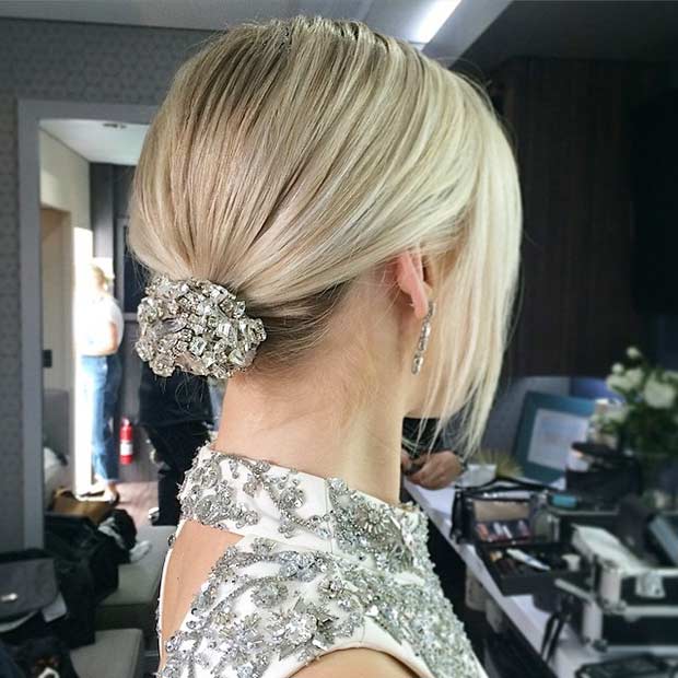 chic minimalist bridal hairstyle on fine straight blonde hair: ponytail bun with strass accessory