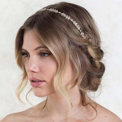 short low bridal updo with loose waves and tiara headpiece on blonde hair