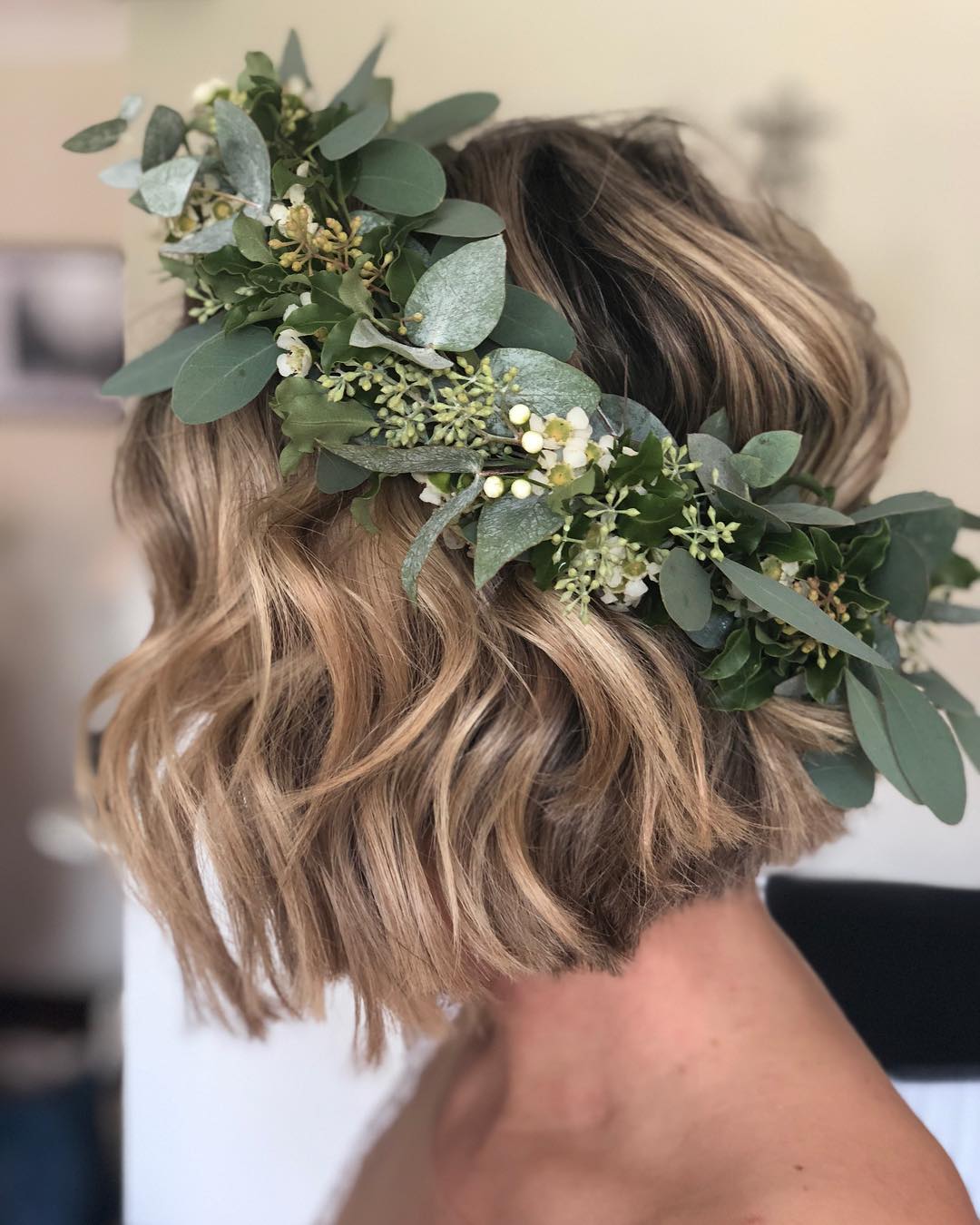 blonde bridal hair on short length hair styled down with beach waves, topped with a gorgeous greenery floral crown