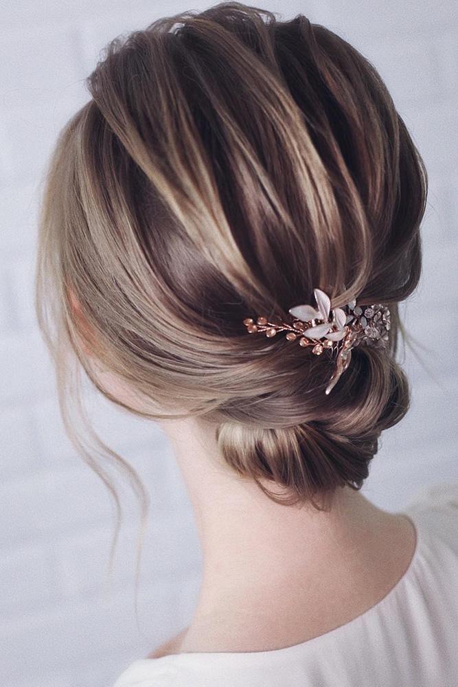 short wedding hairstyle: low bridal hair bun with delicate headpin on blonde hair