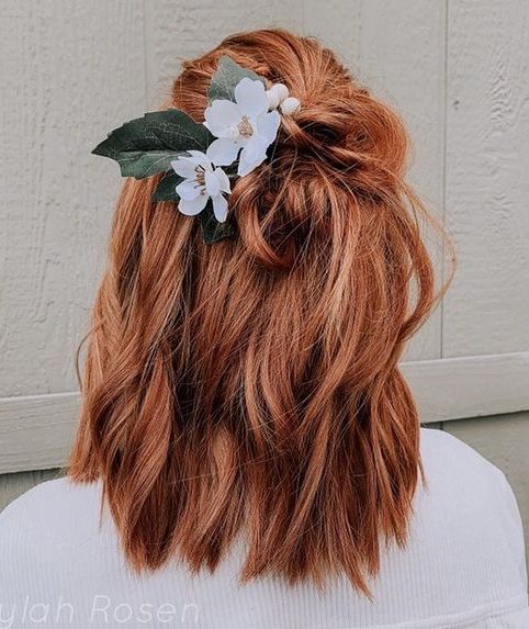 medium length bridal hair with beach waves, half up half down with white flowers on red hair