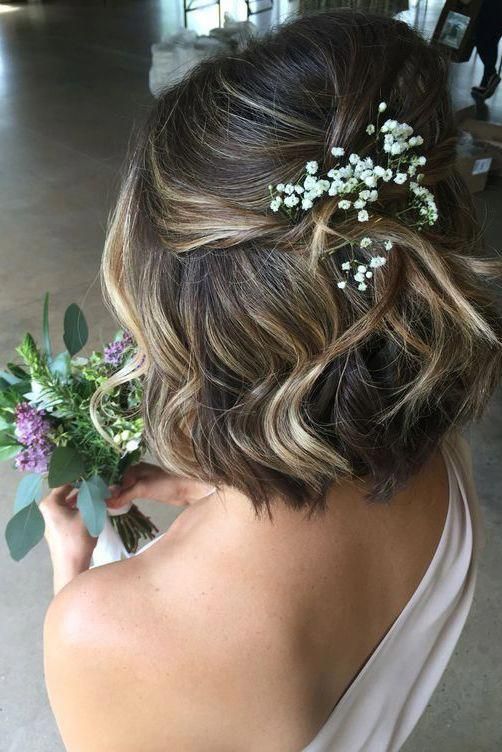 romantic half up half down above the shoulders length bridal hairstyle with loose romantic waves embellished with baby's breath