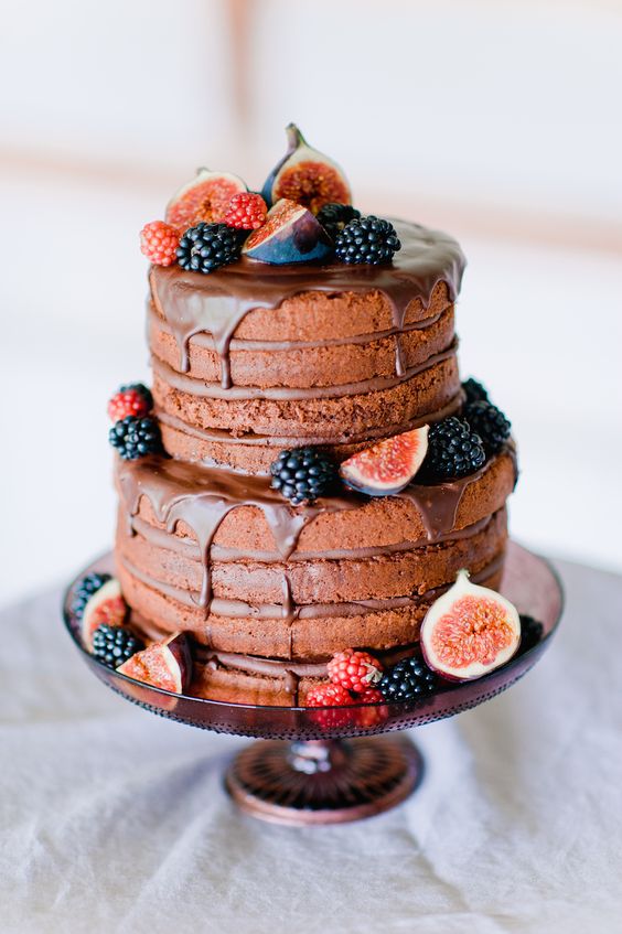 naked chocolate wedding cake with dripping chocolate, topped with blackberries, raspberries and figs