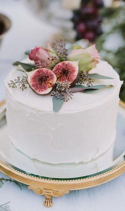 white frosting mini wedding cake topped with roses and figs