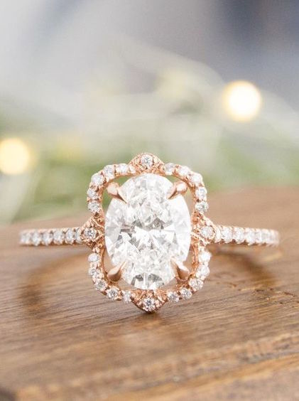 oval shaped engagement ring with a rose gold floral halo setting