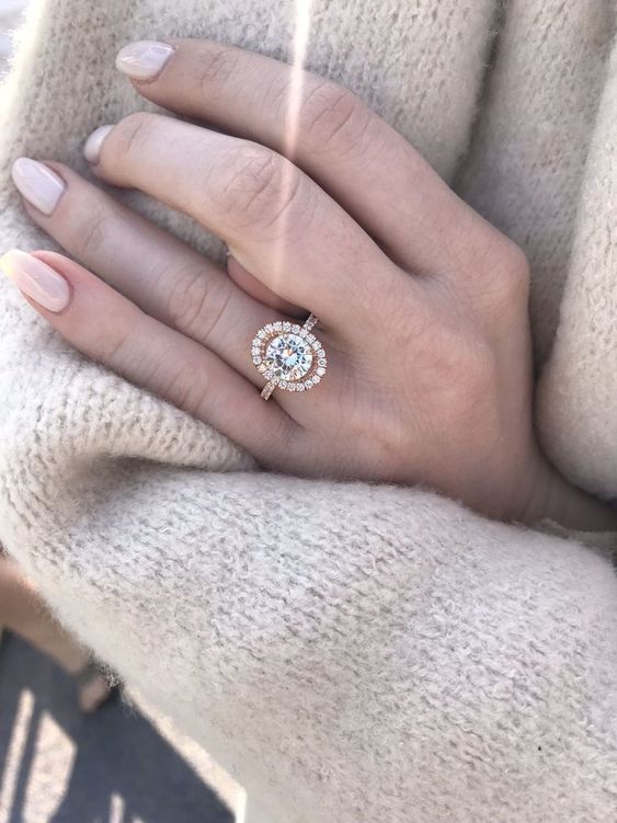 round shaped engagement ring with rose gold oval halo setting