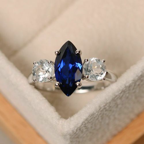 sapphire marquise engagement ring embellished by two side round diamonds