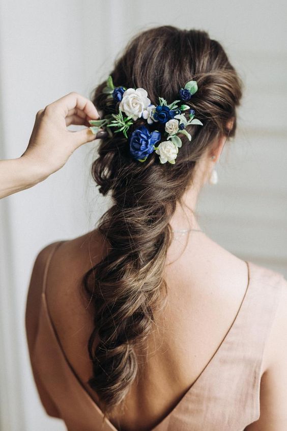 beautiful bridal hairstyle with delicate white and blue flowers