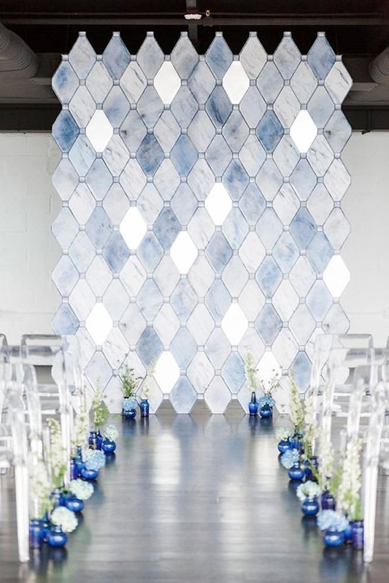 indoor wedding ceremony with a modern mosaic tile in light blue and white colors backdrop