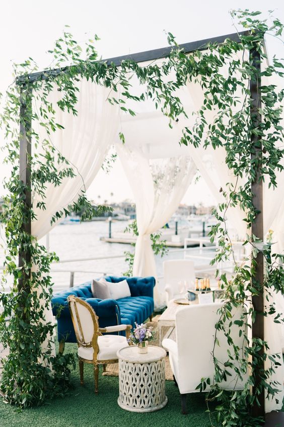 white wedding reception decoration with a blue couch