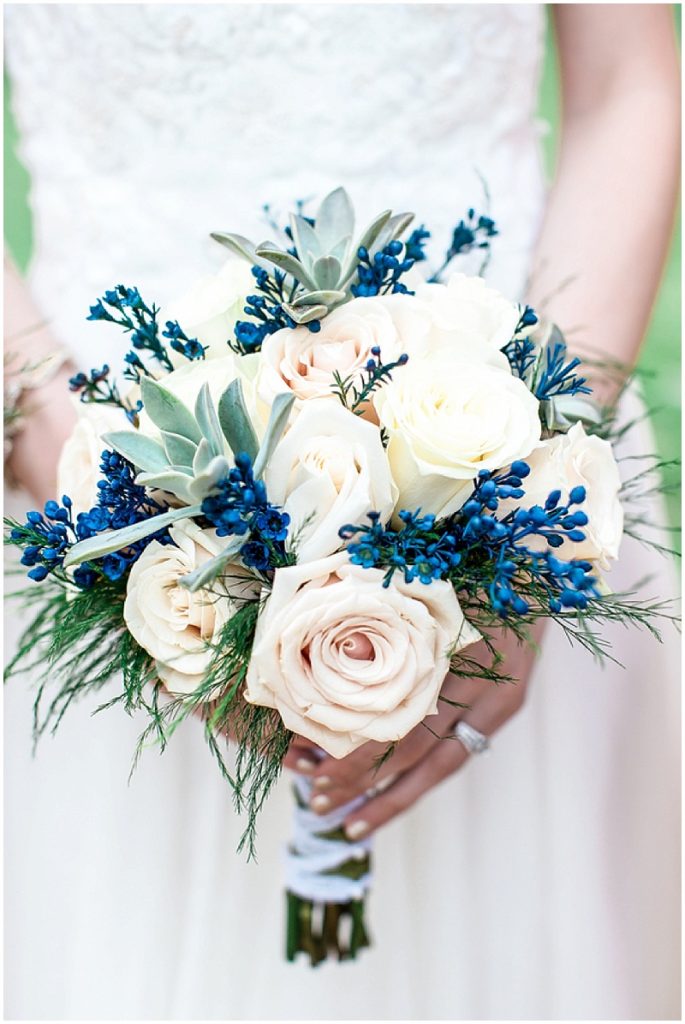 bride holding white flowers bouquet and Pantone Classic Blue accent flowers