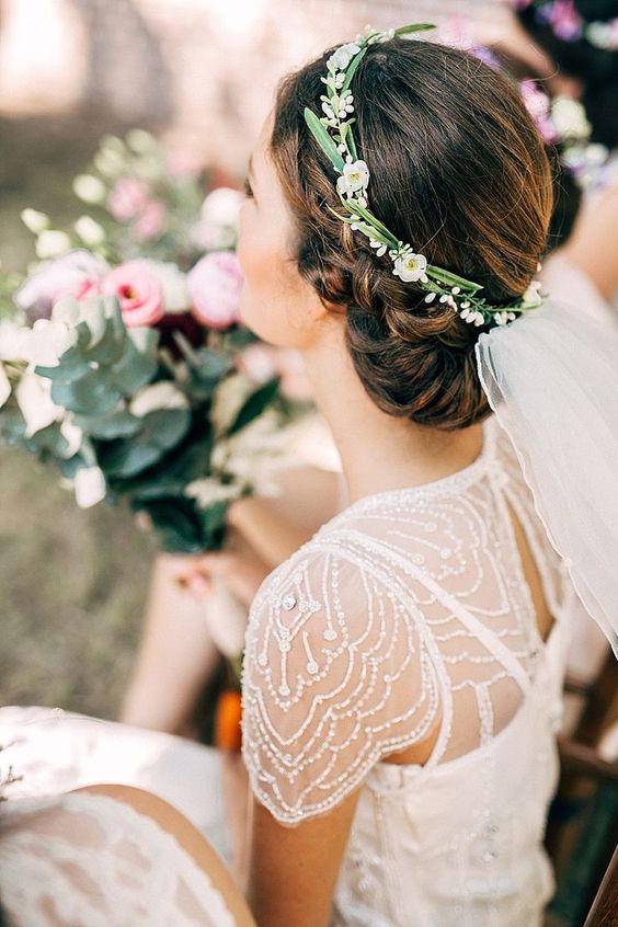 bride wearing hair up with and delicate floral crown and veil