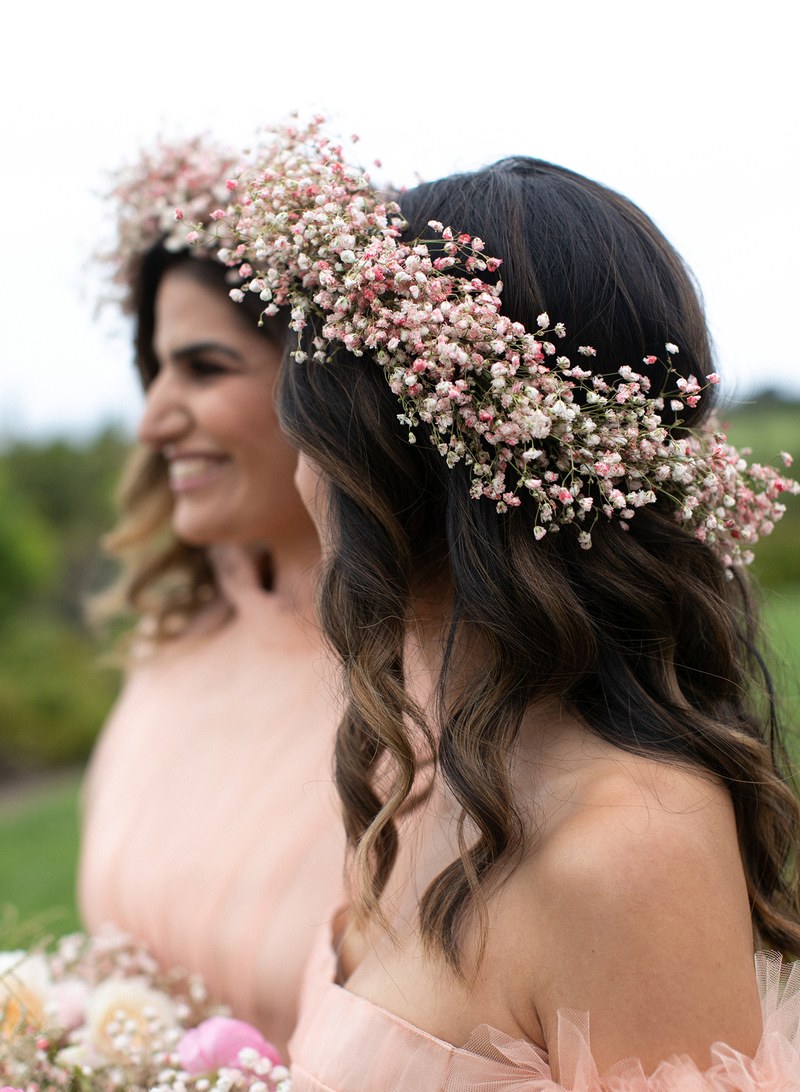 bridesmaids wearing hair down and pink baby's breath floral crown