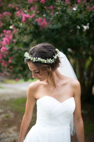 bride wearing hair up with and delicate floral crown and veil