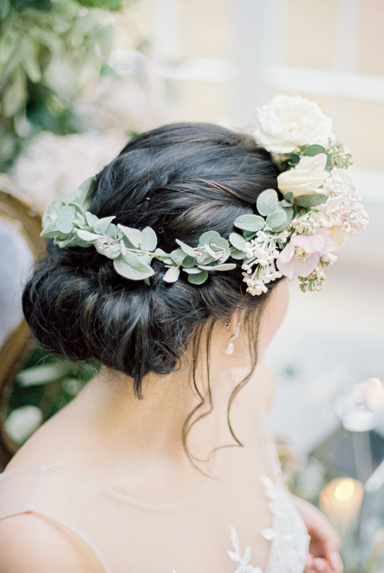 bride wearing hair up and greenery floral crown with white flowers