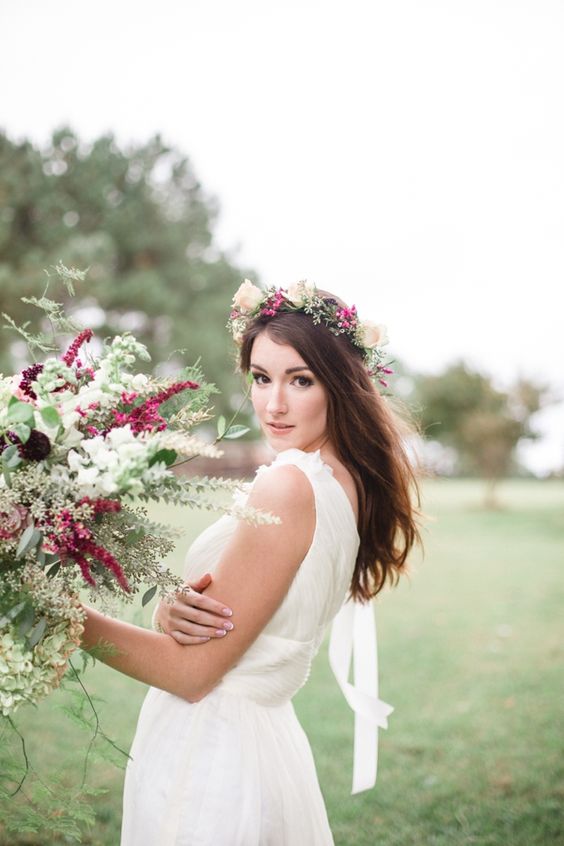 bride wearing hair down and pink flowers floral crown