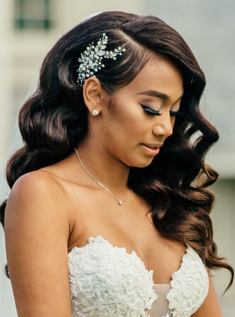 bride wearing her wavy hair down with a side hairpiece