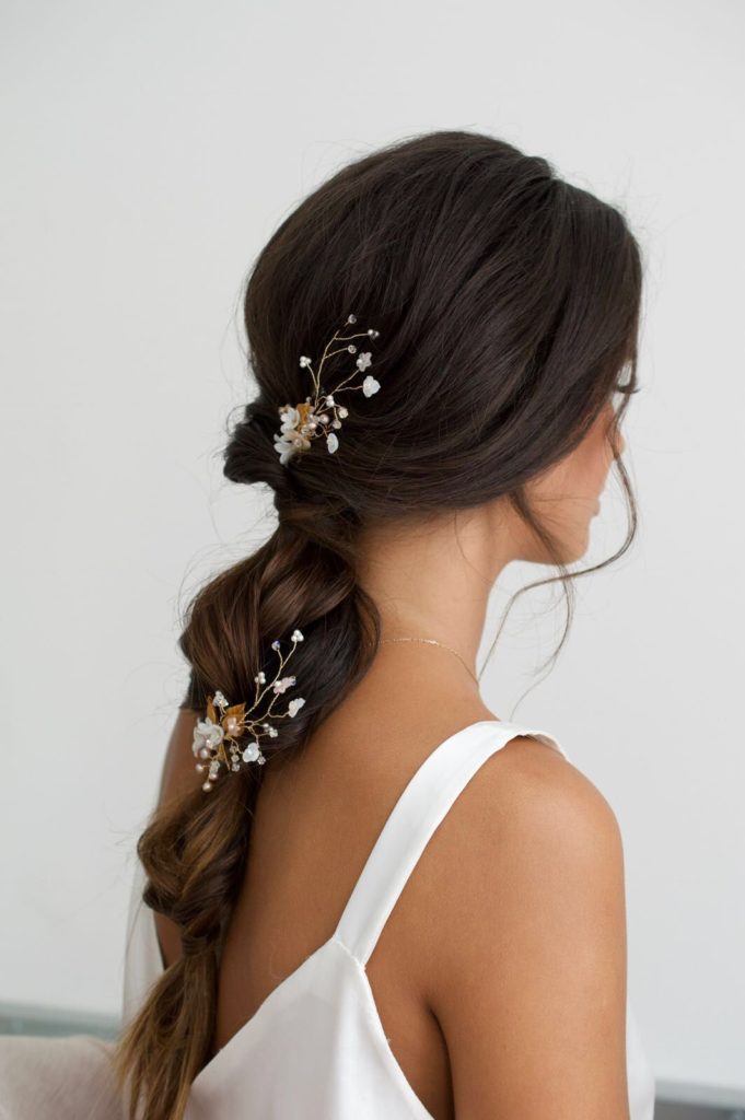 brunette bride wearing a ponytail with small flowers
