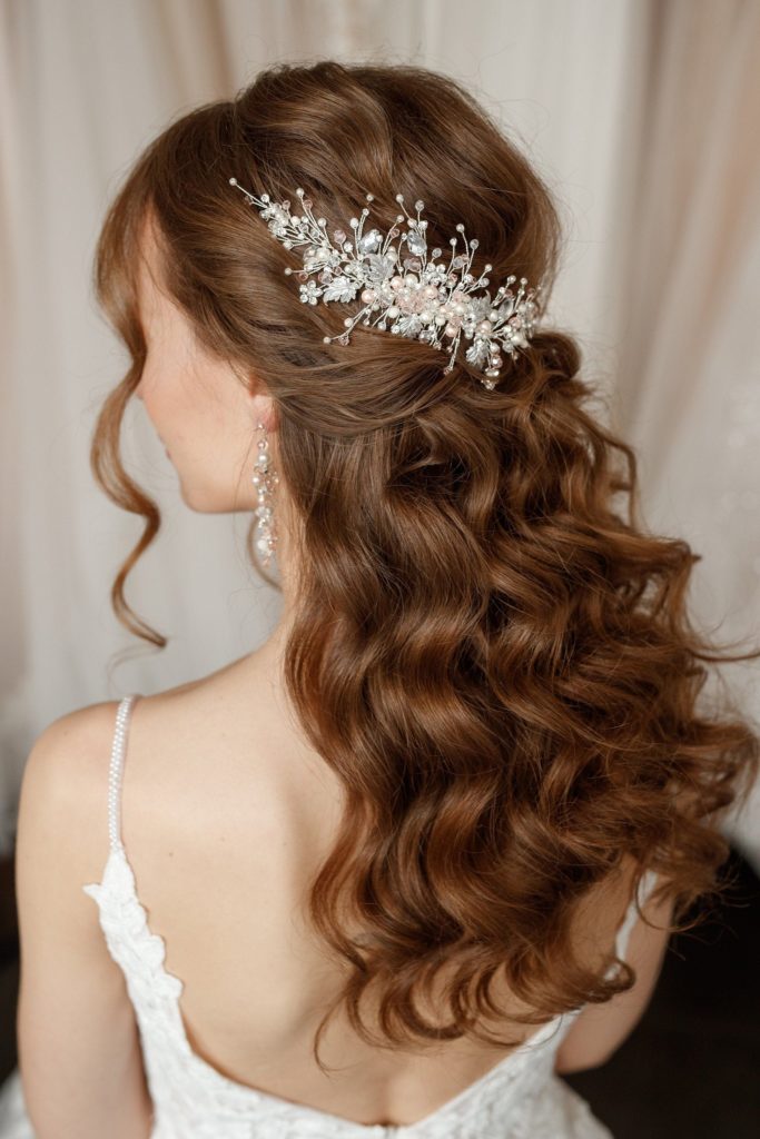 wavy bridal hair styled half up half down with floral headpiece