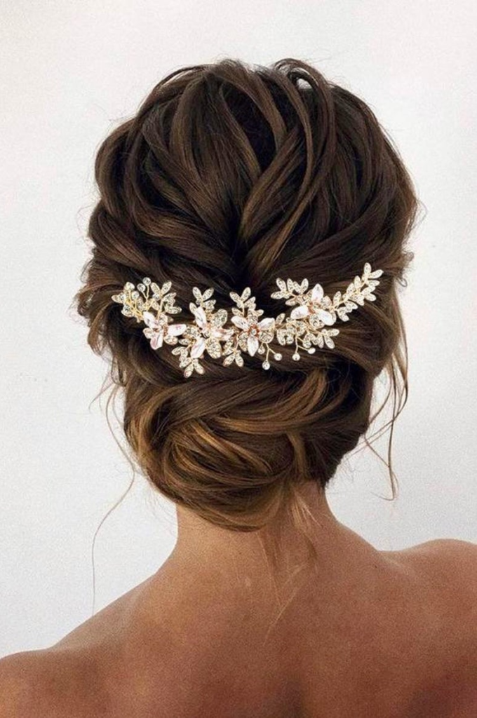brunette bride wearing a low bun with floral headpiece