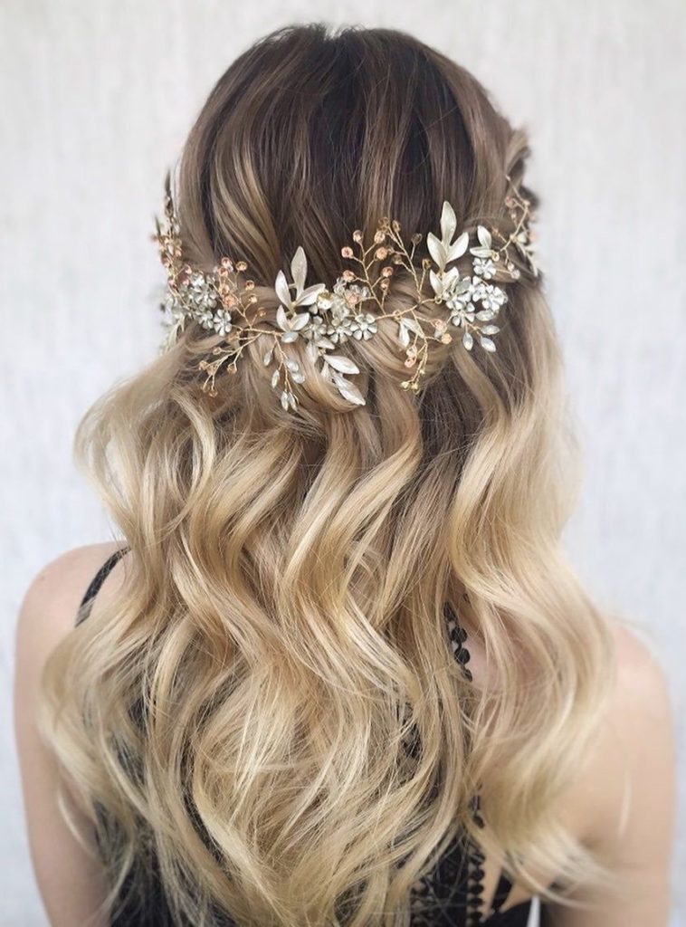 blonde wavy hair styled half up half down with floral headpiece for wedding