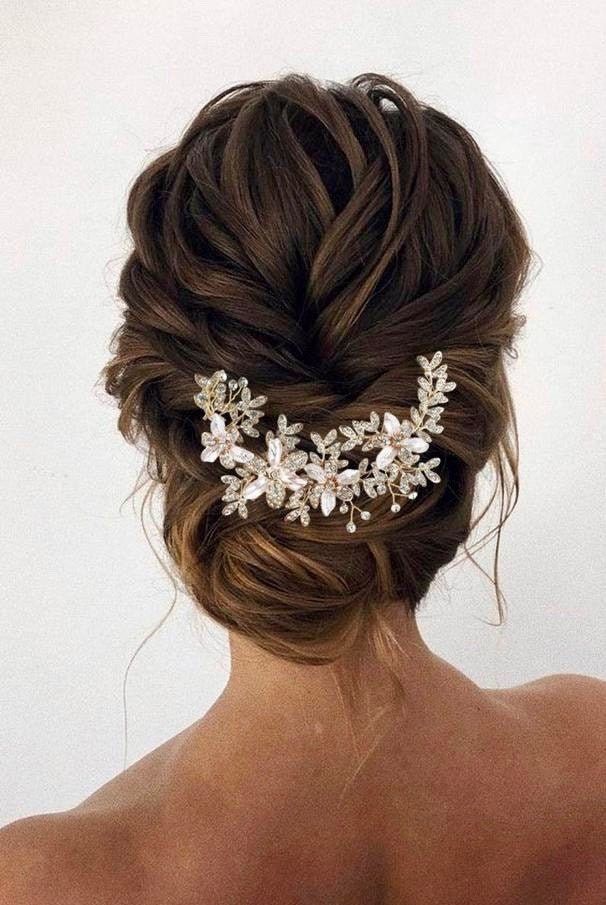brunette bride wearing her hair in a low bun with hair accessory