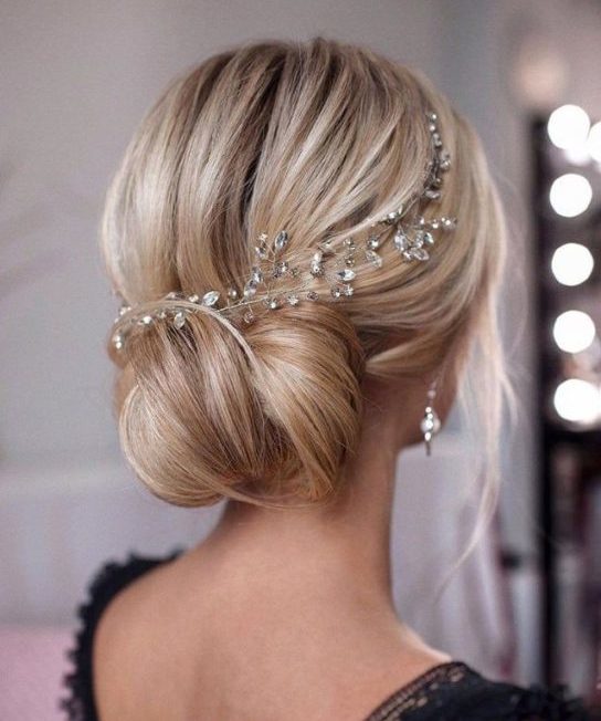 blonde bride wearing her hair in a low bun with delicate hair accessory