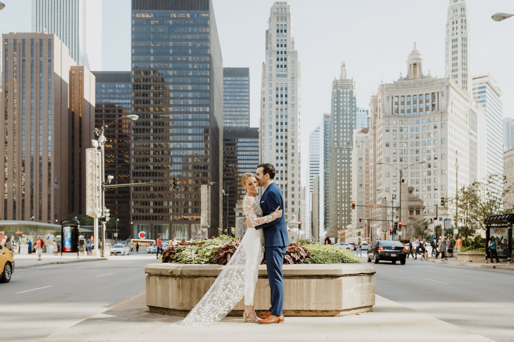 bride and groom hugging in the middle of the city of Chicago after their city hall wedding