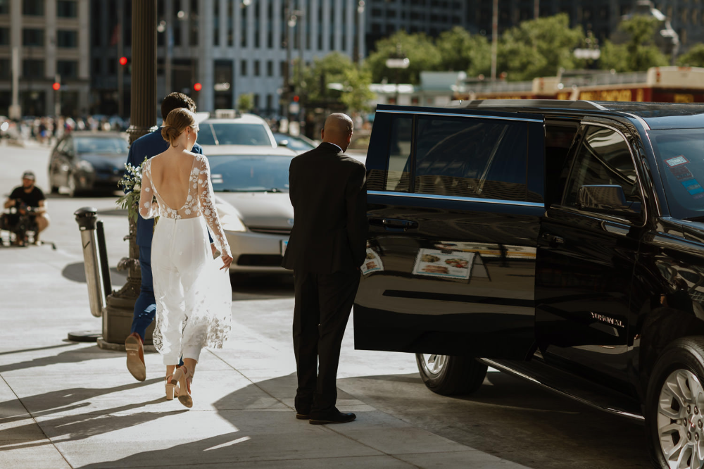 bride and groom walking to a car on their city hall wedding