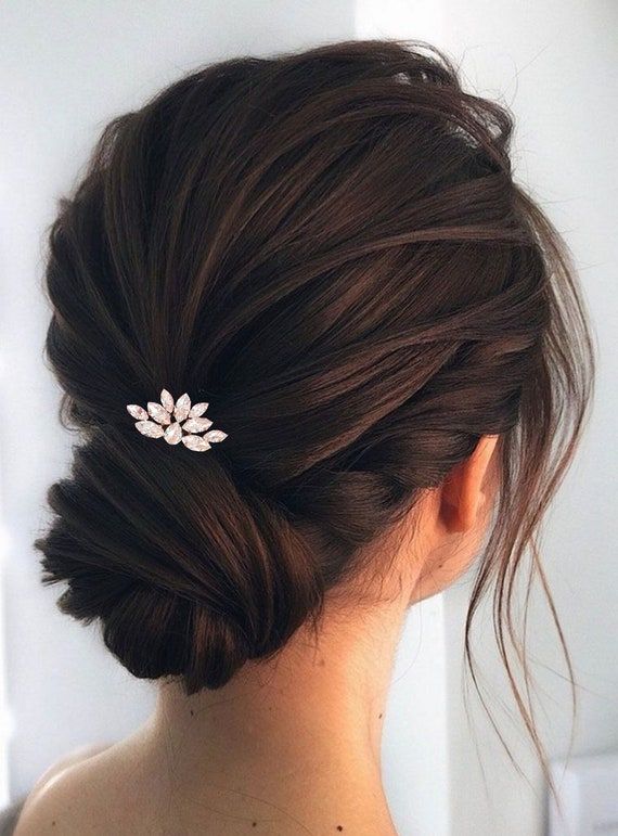 brunette bride wearing her hair in a low bun with small hair accessory