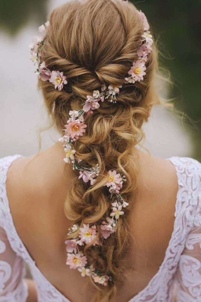 boho wedding hairstyle with pink flowers and messy braid