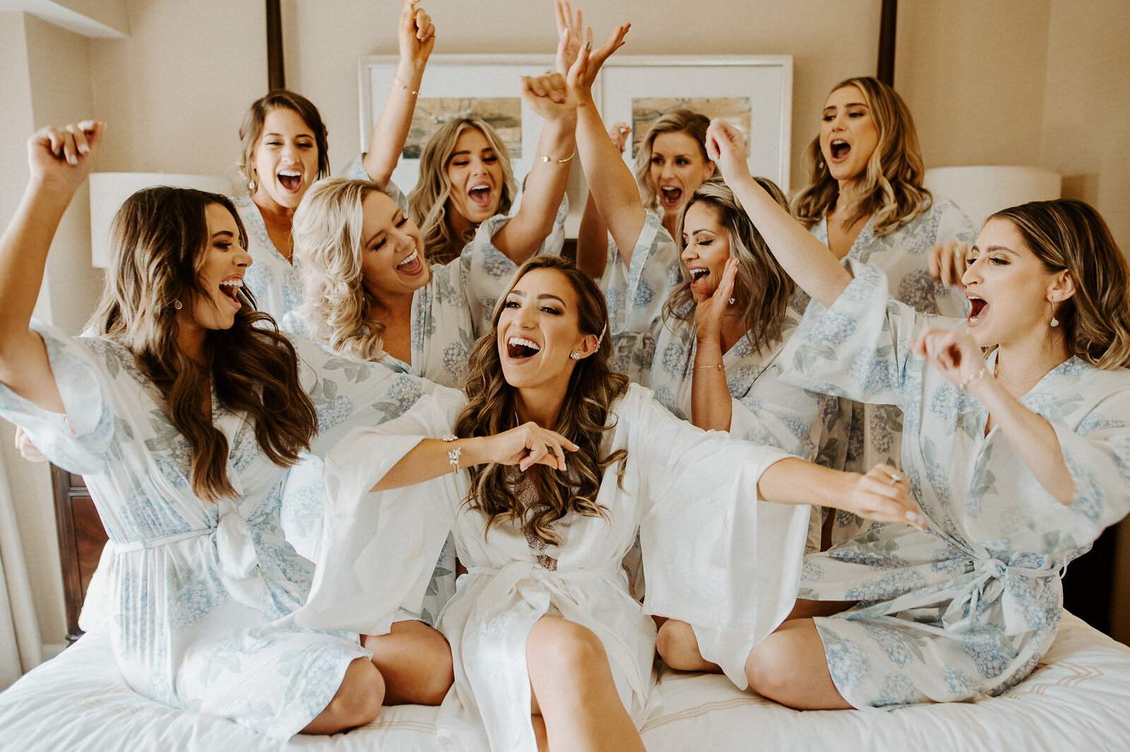 bridal party and bride getting ready photo wearing robes