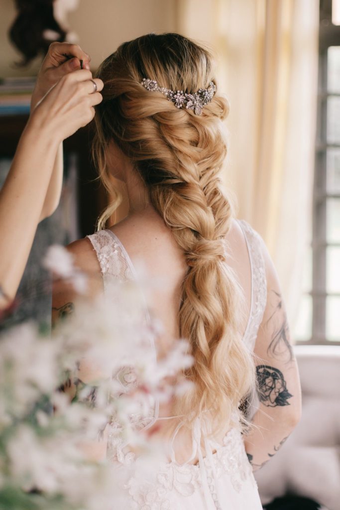 bride with long blonde hair braided for her wedding day